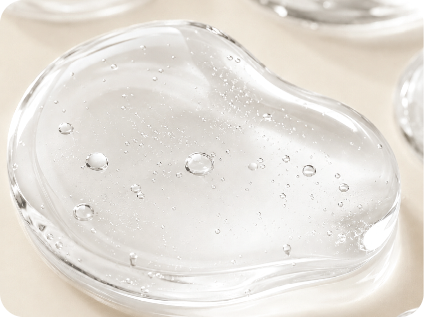 Clear gel-like substance with bubbles on a beige background