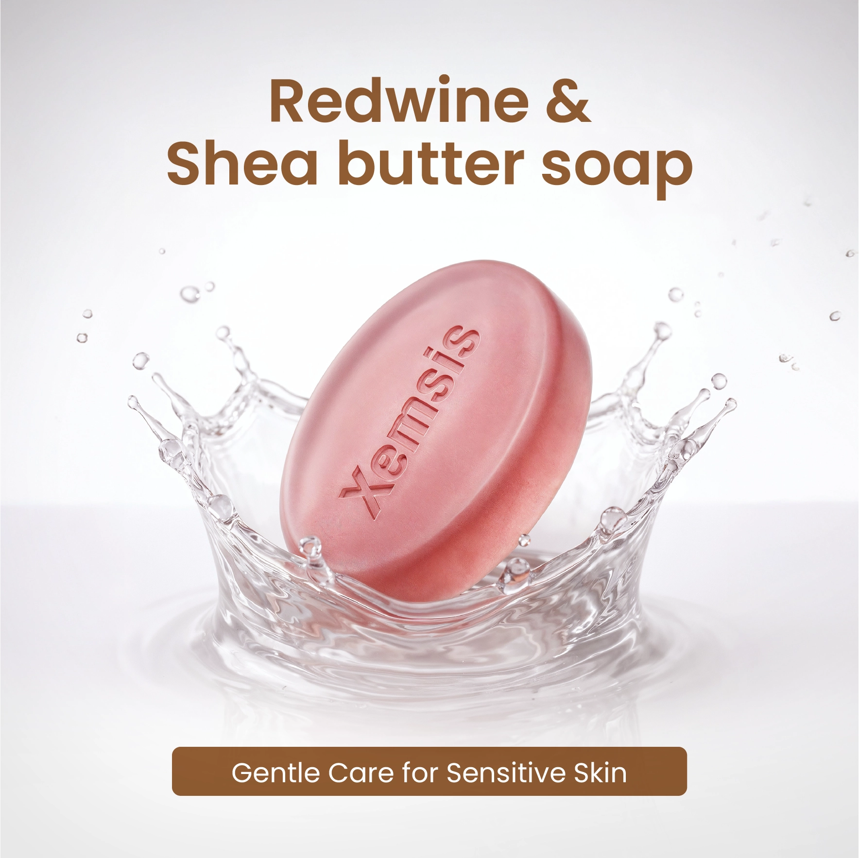 Pink soap bar with 'Xemsis' branding in water, labeled 'Redwine & Shea butter soap' on a light gray background